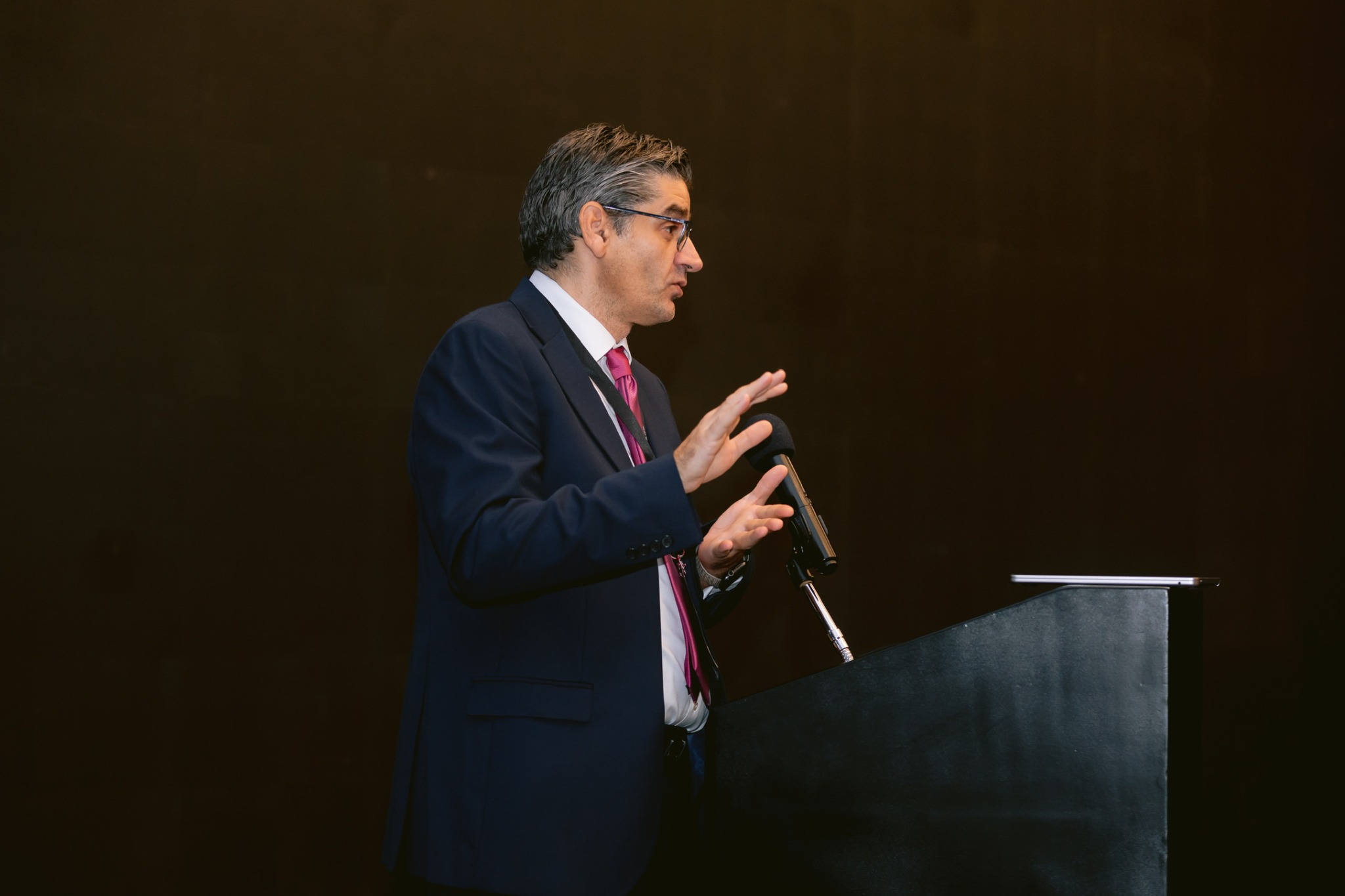 Professor Athanasios Diamantopoulos speaking at a lectern